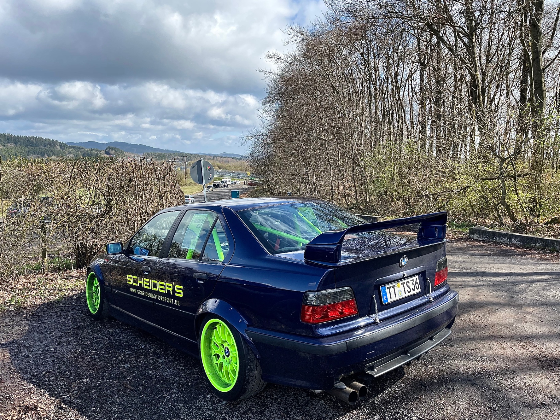 Scheider's Motorsport BMW E36 with neon green wheels parked near the Nordschleife